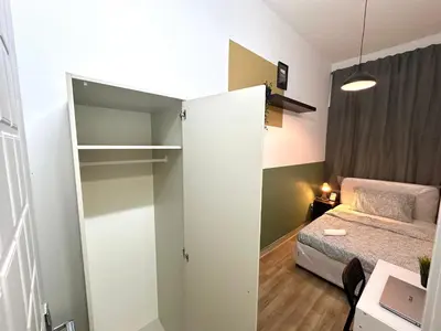 a small bedroom with a bed and a closet at Passion Nest Room in Barsha Heights Tecom in Dubai