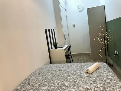 a bedroom with a bed and a table and a mirror at Passion Nest Room in Barsha Heights Tecom in Dubai