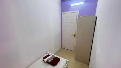 a small white room with a bed and a door at Solo Haven Room in Barsha Heights Tecom in Dubai
