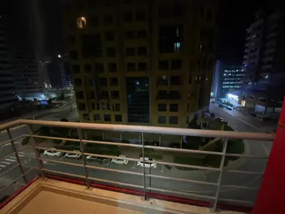 a view of a city at night from a balcony at Solo Haven Room in Barsha Heights Tecom in Dubai
