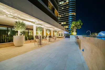 a building with a bar with tables and chairs at Luxury Oasis | Private Beach & Infinity Pool in Dubai