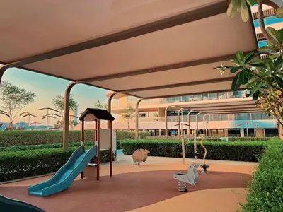 a playground in a building with a slide and swings at Luxury Oasis | Private Beach & Infinity Pool in Dubai
