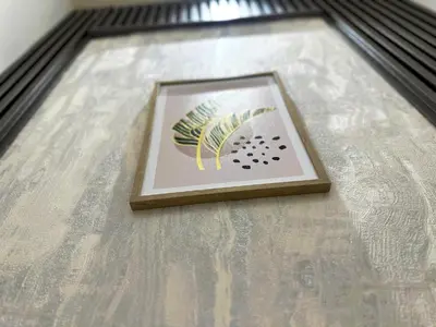 a framed picture of a plant on a table at Best Solo Room in Barsha heights Tecom in Dubai