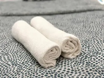 a pair of towels sitting on top of a bed at Best Solo Room in Barsha heights Tecom in Dubai