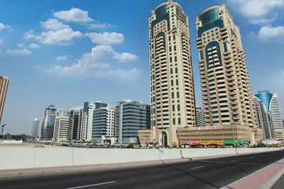 a city with two tall buildings and a street at Best Solo Room in Barsha heights Tecom in Dubai