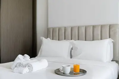 a hotel room with two beds and a tray of towels at Ultra Luxury Apt | Private Beach + Infinity Pool in Dubai