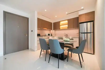 a kitchen and dining room with a table and chairs at Ultra Luxury Apt | Private Beach + Infinity Pool in Dubai