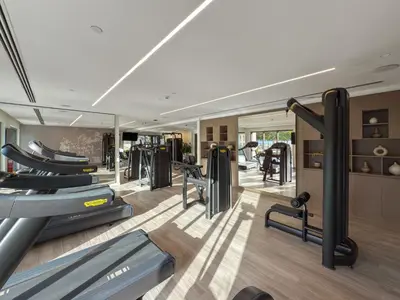 a gym with treadmills and exercise equipment in a room at 2BR Burj Khalifa Dubai Mall View in Dubai