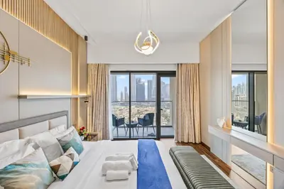 a bedroom with a bed and a large window at 2BR Burj Khalifa Dubai Mall View in Dubai