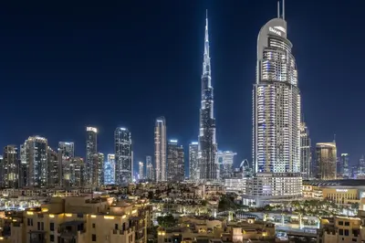 a city skyline at night with a tall skyscraper at 2BR Burj Khalifa Dubai Mall View in Dubai