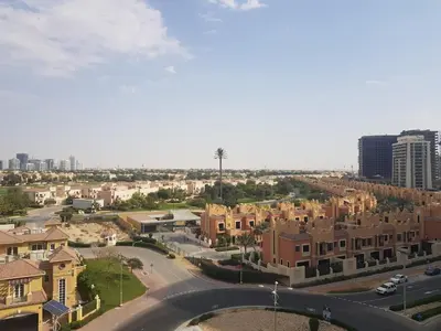 an aerial view of a residential neighbourhood with buildings at Cricket Tower in Dubai