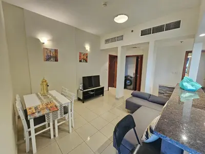 a living room with a table and a couch at Cricket Tower in Dubai