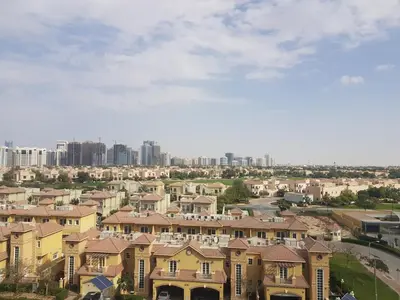 a group of houses in a city with buildings at Cricket Tower in Dubai
