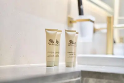 a couple of bottles of sunscreen sitting on a counter at Jacuzzi Canal view BusinessBay in Dubai