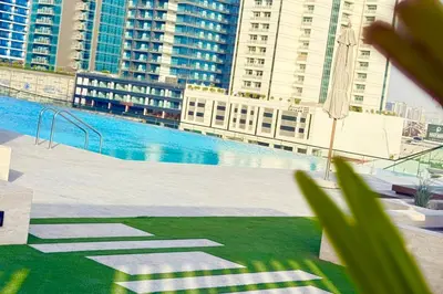 a large swimming pool in a city with tall buildings at Jacuzzi Canal view BusinessBay in Dubai