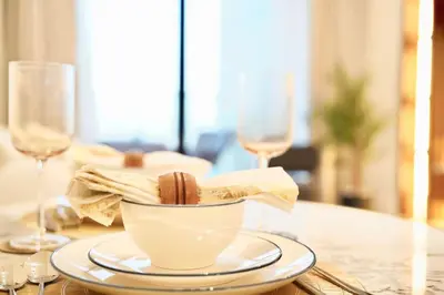 a table with a bowl and two wine glasses at Jacuzzi Canal view BusinessBay in Dubai