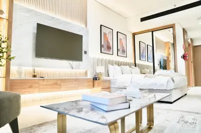 a living room with a couch and a tv at Canal View Studio Jacuzzi in Dubai