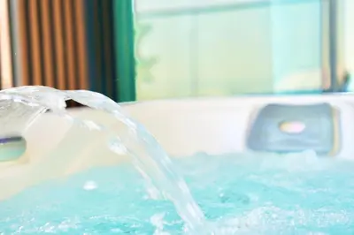 a stream of water coming out of a bath tub at Canal View Studio Jacuzzi in Dubai