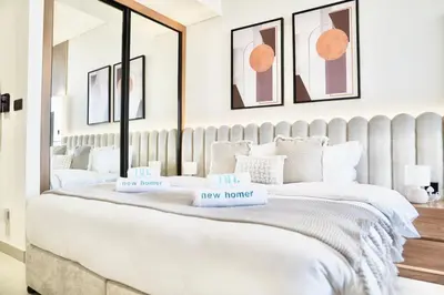 a bedroom with a large bed with two boxes on it at Canal View Studio Jacuzzi in Dubai
