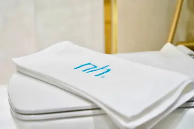 a white object with the letter m on it at Exclusive Jacuzzi Canal View in Dubai