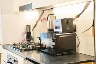 a kitchen with a coffee maker on top of a counter at Exclusive Jacuzzi Canal View in Dubai