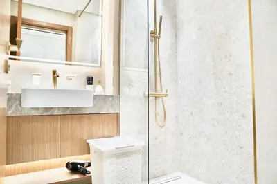 a bathroom with a shower and a sink at Exclusive Jacuzzi Canal View in Dubai