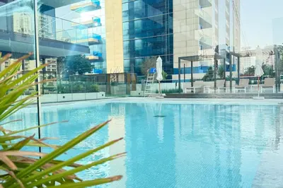 a large swimming pool in a large building at Luxury Studio w Jacuzzi Balcony in Dubai