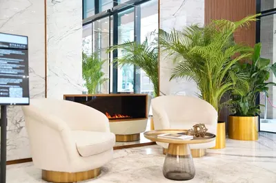 a lobby with two chairs and a fireplace at Luxury Studio w Jacuzzi Balcony in Dubai