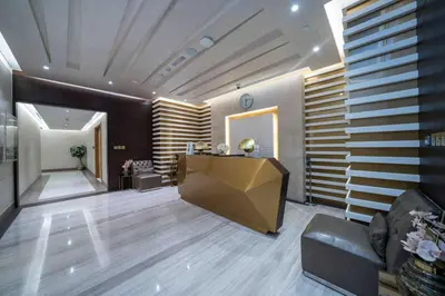 a lobby with a desk in the middle of a room at Chic Waterfront 1 Bed with Panoramic Marina Views in Dubai