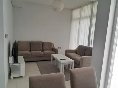 a living room with a couch and a table at Damac hills 2 vardon cluster townhouse in Dubai