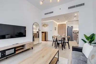 a living room with a couch and a table with chairs at GLOBALSTAY Elegant Meydan Apartments - Azizi Riviera 40 in Dubai