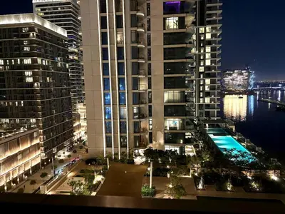a view of a large building at night at Palm View Marina Vista 1BR Beachfront in Dubai