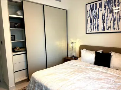a bedroom with a large bed and a closet at Palm View Marina Vista 1BR Beachfront in Dubai
