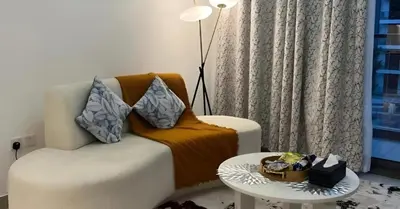 a living room with a couch and a table at Laya Heights Residence by Hogar in Dubai