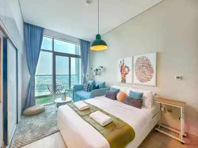 a large bed in a room with a large window at Minimal Studio in Marina Sea View in Centric & Top Building in Dubai