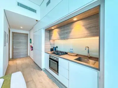 a kitchen with white cabinets and a sink at Minimal Studio in Marina Sea View in Centric & Top Building in Dubai