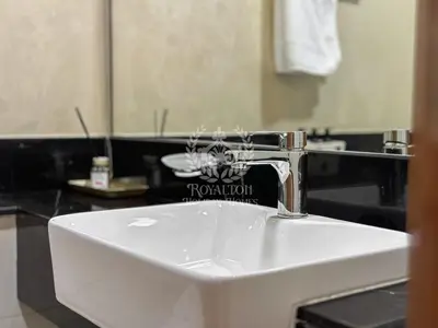 a bathroom sink with a faucet on top of it at Royalton - Cozy Studio with Burj Khalifa & Canal Views in Dubai