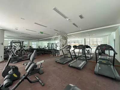 a gym with a bunch of treadmills and exercise bikes at Royalton - Cozy Studio with Burj Khalifa & Canal Views in Dubai