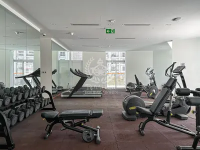 a gym with several treadmills and exercise bikes at Royalton - Cozy Studio with Burj Khalifa & Canal Views in Dubai
