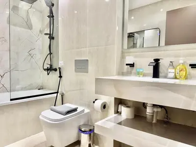 a bathroom with a toilet and a sink and a mirror at Renovated 2bdr in Sadaf 7 JBR in Dubai