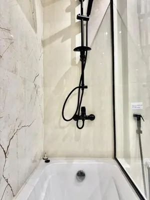 a bathroom with a bath tub with a candle above it at Renovated 2bdr in Sadaf 7 JBR in Dubai