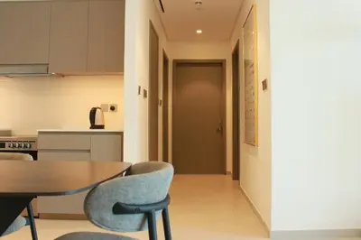 a kitchen and dining room with a table and chairs at Next to Burj Khalifa 5 Mins Walk To Dubai Mall in Dubai