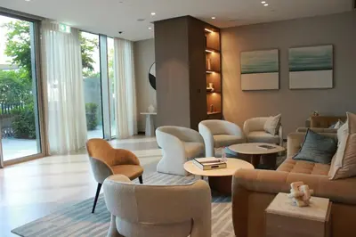 a living room with chairs and a couch and tables at Next to Burj Khalifa 5 Mins Walk To Dubai Mall in Dubai
