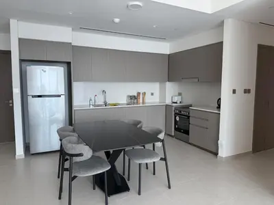 a kitchen with a black table and chairs at Next to Burj Khalifa 5 Mins Walk To Dubai Mall in Dubai