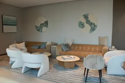 a living room with a couch and tables and chairs at Next to Burj Khalifa 5 Mins Walk To Dubai Mall in Dubai