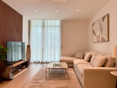 a living room with a couch and a tv at DAYF-POLO Modern 1BR Escape Polo Residences Meydan in Dubai