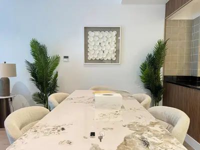 a conference room with a table and chairs at DAYF-POLO Modern 1BR Escape Polo Residences Meydan in Dubai