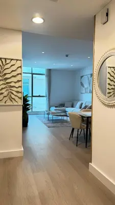 a living room with a couch and a table at DAYF-POLO Modern 1BR Escape Polo Residences Meydan in Dubai