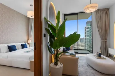 a hotel room with a bed and a plant at Tranquil 1Bedroom in Binghatti Gardenia in Dubai