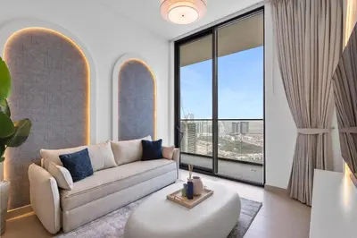 a living room with a couch and a large window at Tranquil 1Bedroom in Binghatti Gardenia in Dubai